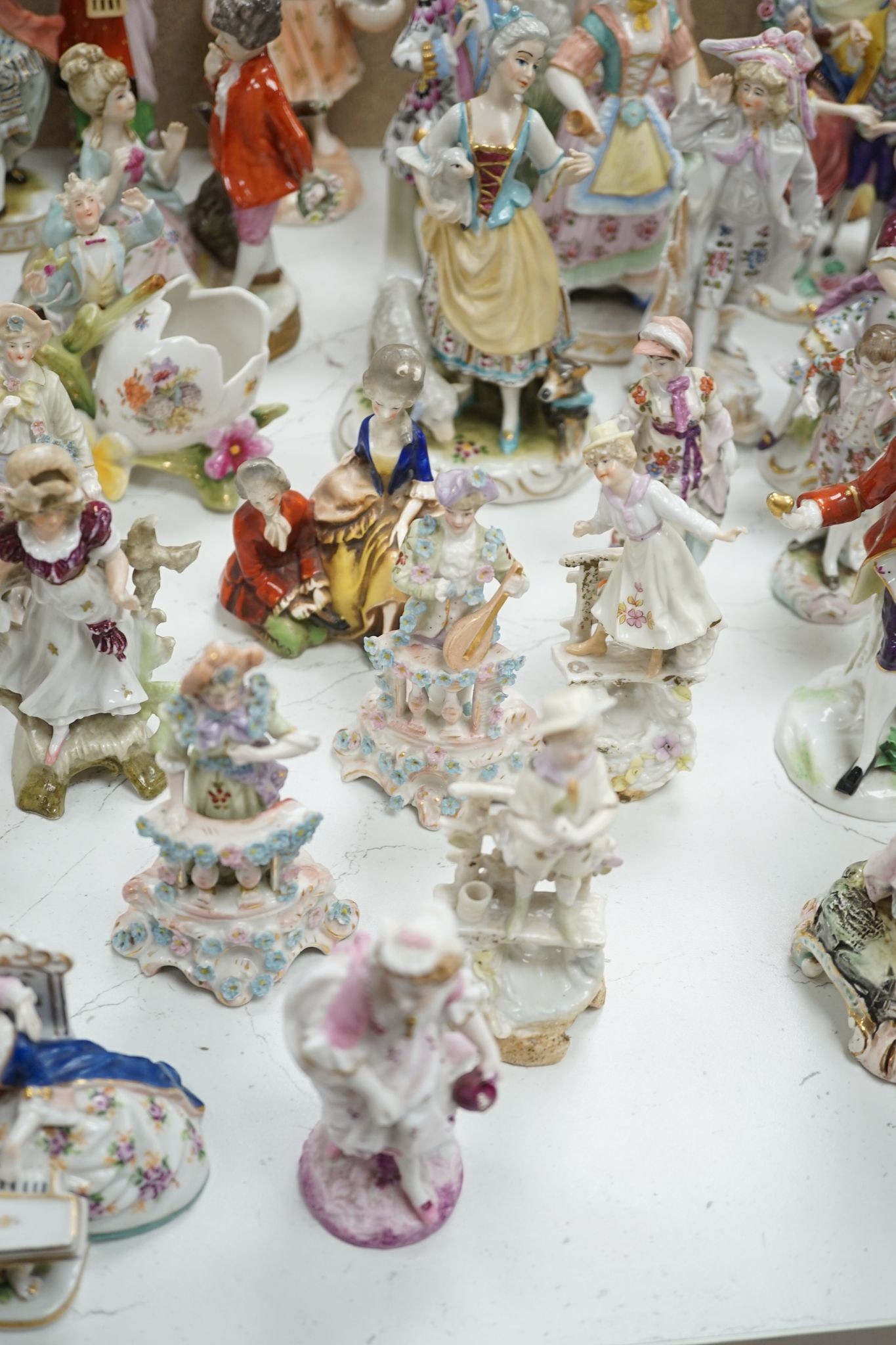 A large collection of small to medium German, French and English porcelain figurines and groups, tallest 18cm